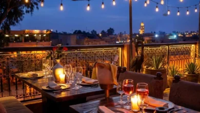 Can you drink alcohol in Morocco — rooftop restaurant in Marrakech with wine glasses and candlelight overlooking the medina at night
