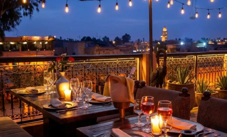 Can you drink alcohol in Morocco — rooftop restaurant in Marrakech with wine glasses and candlelight overlooking the medina at night