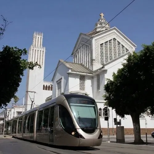 Christian cathedral in Rabat with a modern tramway passing in front, reflecting Morocco's religious pluralism and why Morocco is safe for Americans of all faiths including Christians.
