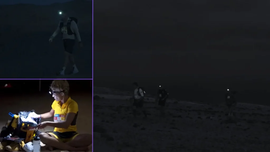 Runners with headlamps crossing the Sahara at night during the long stage of Marathon des Sables