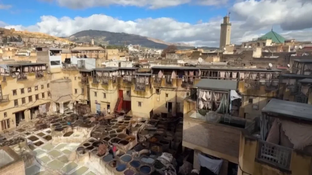Aerial view of the Chouara Tannery in Fez with stone dyeing vats — leather goods are a must when choosing what to buy in Fez