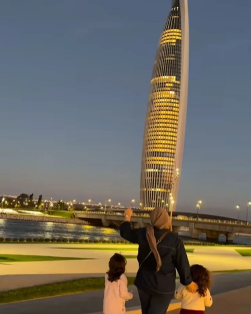 Mohammed VI Tower ticket price for families — the illuminated tower at dusk viewed from the Bouregreg promenade