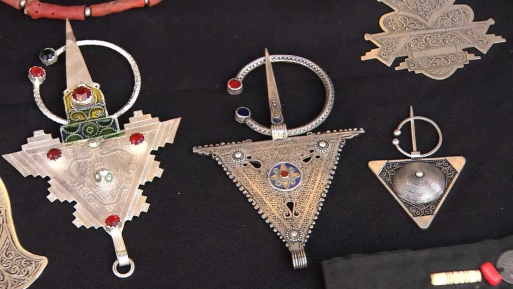 : Traditional silver Amazigh fibula brooches with enamel and gemstone details — Berber jewelry is a culturally rich option for what to buy in Tiznit
