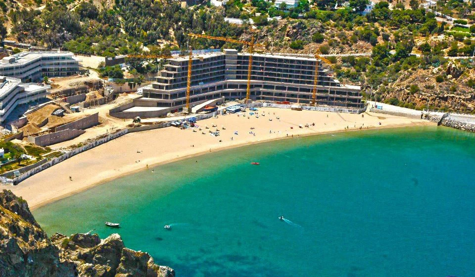 Aerial view of Quemado beach in Al Hoceima Morocco with turquoise Mediterranean water and green hills surrounding the bay