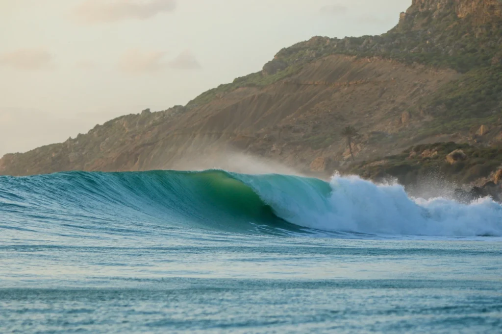 A powerful turquoise wave breaking at Anchor Point near Taghazout, one of the best surf spots in Morocco