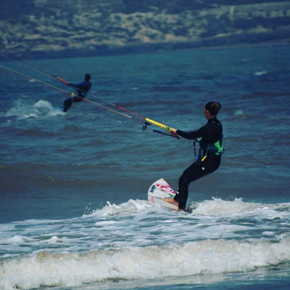 Kitesurfer riding the waves in Essaouira Morocco powered by the strong Alizé trade winds