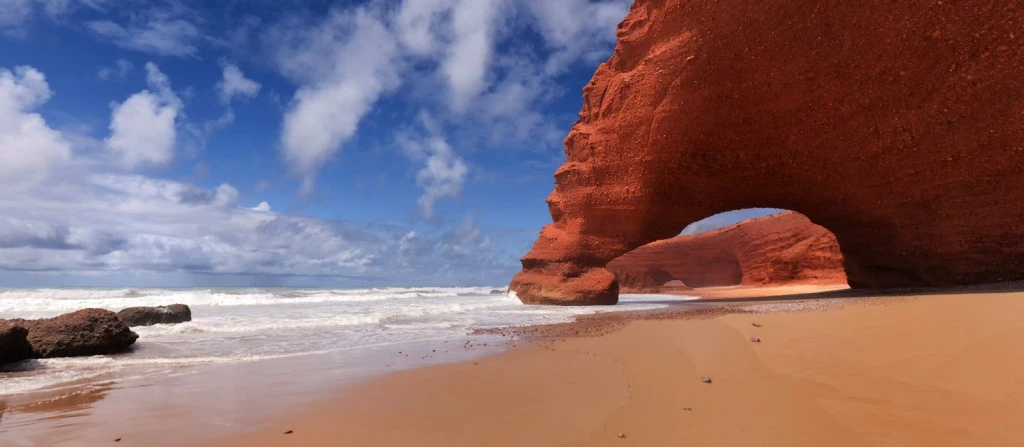 The iconic red rock arch of Legzira beach near Sidi Ifni, one of the most photographed Morocco beaches on the Atlantic coast