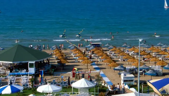 Saïdia beach in Morocco with rows of umbrellas and swimmers in the calm Mediterranean water, the longest beach in the country