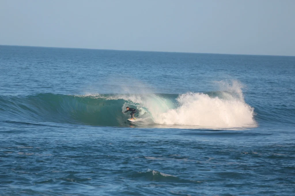 Surfer dropping into a hollow wave at Imsouane Morocco, home to the longest rideable wave in Africa