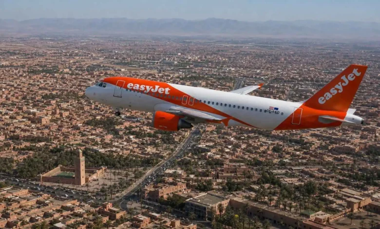 EasyJet Airbus A319 flying over Marrakech with the Koutoubia Mosque and Atlas Mountains visible, illustrating the new Strasbourg-Marrakech direct flight