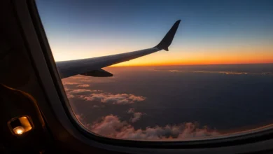 View of the Moroccan coastline at sunrise from the window of a transatlantic aircraft, illustrating the experience of flights to Morocco from NYC.