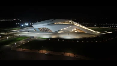 Night view of The Royal Theatre of Rabat illuminated along the Bouregreg riverfront in Rabat, Morocco.