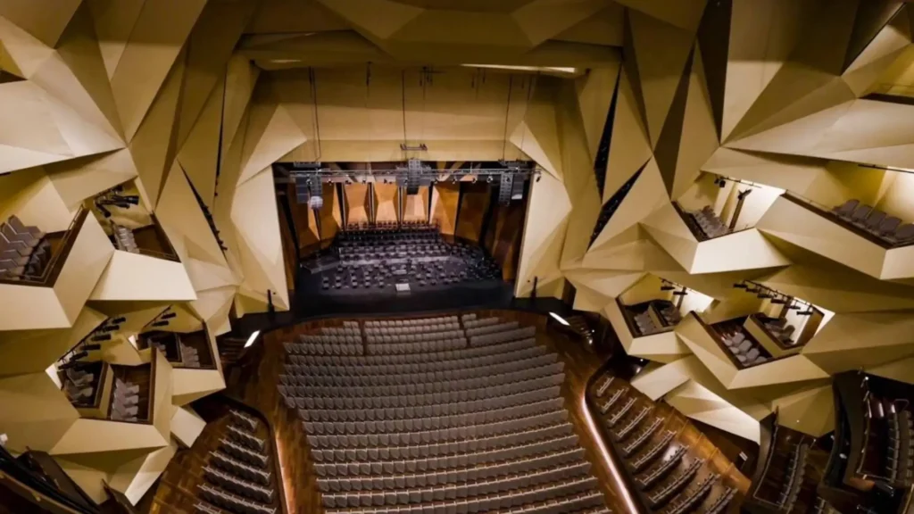 Interior view of TheRoyal Theatre of Rabat showing its dramatic geometric auditorium, modern stage, and layered angular architecture inspired by Moroccan muqarnas design.